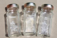 vintage-Griffiths-glass-bottle-spice-set-12-clear-jars-for-spices-wood-wall-rack-Laurel-Leaf-Far.jpg