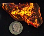 Svabite, Langban Mine, Filipstad, Sweden, US dime for scale, SW 254 nm.JPG